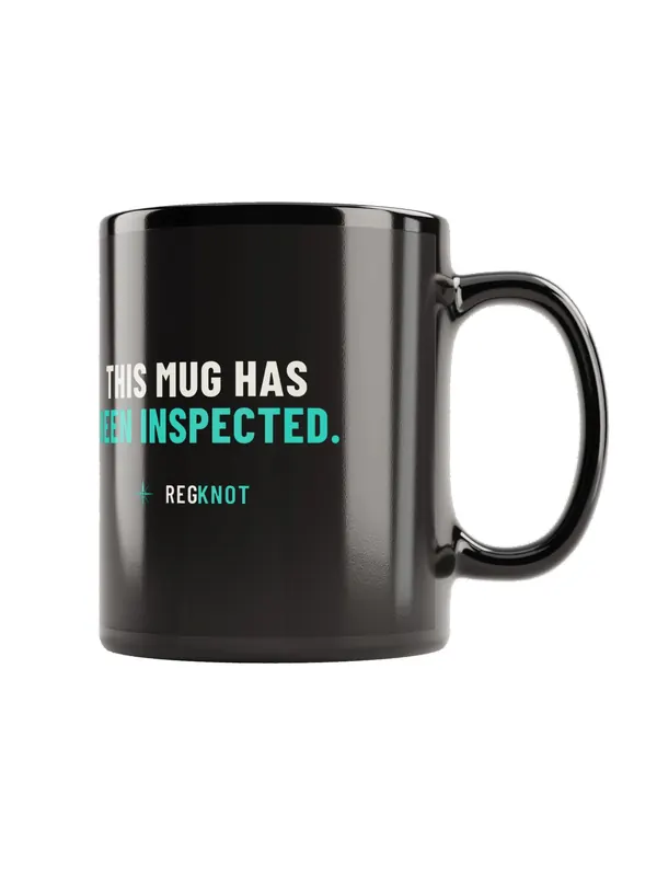 Black mug printed “This mug has been inspected.” with the RegKnot logo